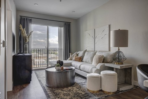 a living room with a white couch and a balcony